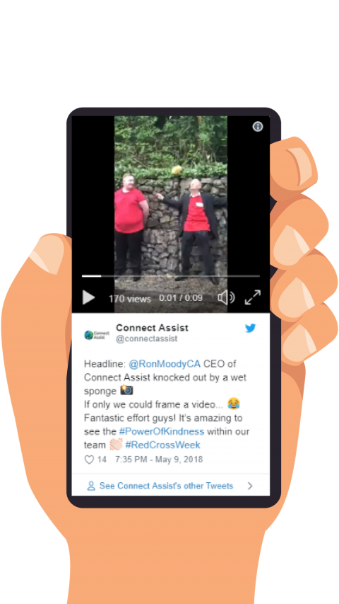 hand holding a phone with twitter video up showing our CEO getting wet sponges thrown at him for charity